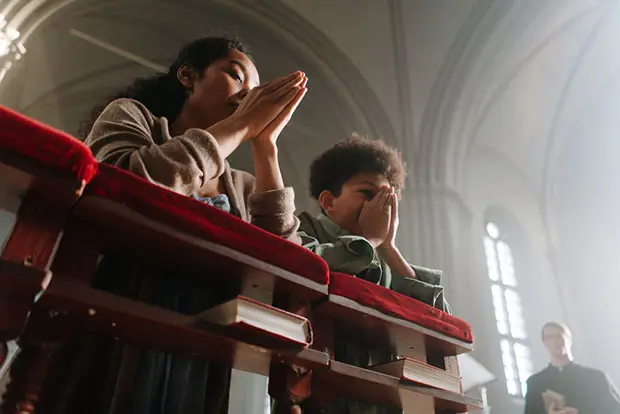 Gläubige sitzen in einer katholischen Kirche und beten an einem Feiertag